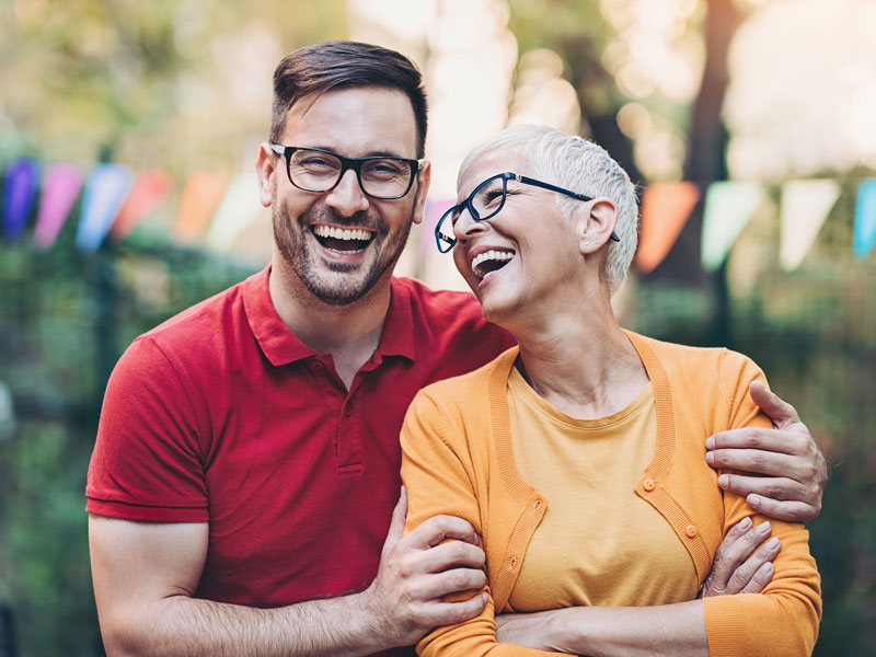 mother and adult son laughing together